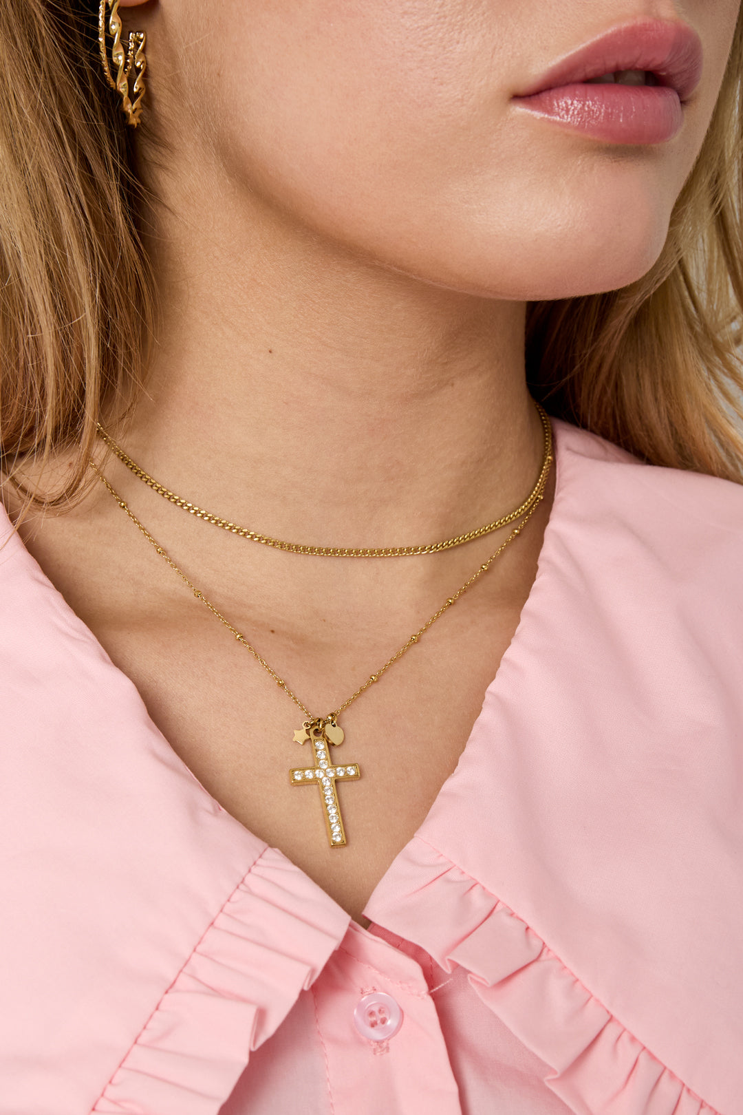 Necklace with decorated cross pendant and charms