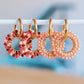 Oorrel met ronde facet hanger - roze/rood