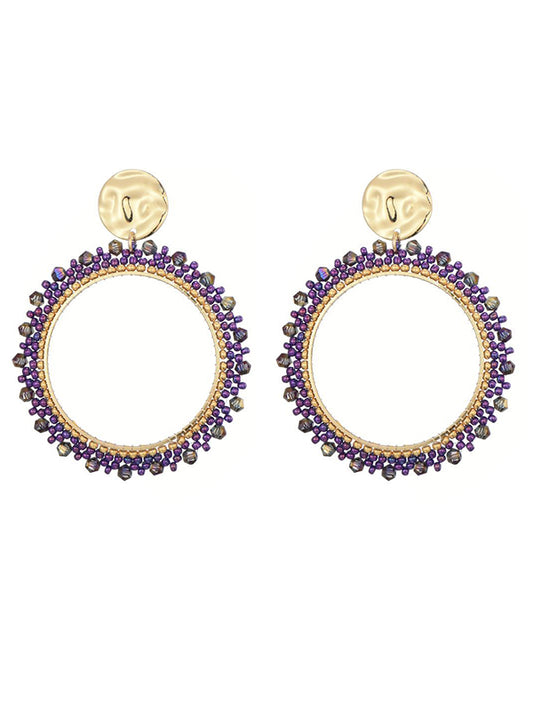 Goudkleurige oorbellen met paarse miyuki beads